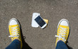 © creativefamily - Disassembled smartphone on the ground in front of person