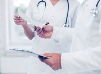 Wall Mural - two doctors writing prescription