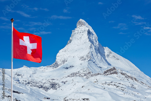 Fotografie, Obraz Famous Matterhorn with flag of switzerland