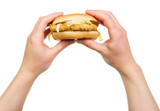 Fototapeta Tęcza - In female hands  hamburger isolated on white background.