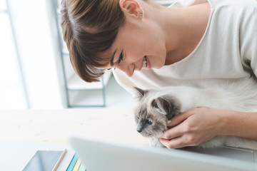 Wall Mural - Woman cuddling her cat