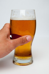 Glass of light beer and male hand , isolated on a white backgrou