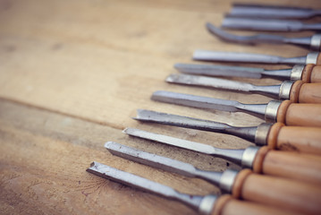 Top view of chisel tools set on wooden surface, closeup flat lay