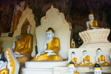 Many Buddha statues sit, religious carving. Hpa-An, Myanmar. Burma.