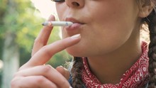 Close Up Shot Of Young Woman Smoking In Park, Slow Motion