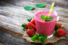 Summer  Strawberry Smoothie On Rustic Wooden Background