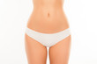 © deagreez - Close up photo of attractive white woman's panties and slim stom