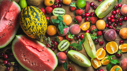 Various colorful tropical fruit selection on rustiv wooden background