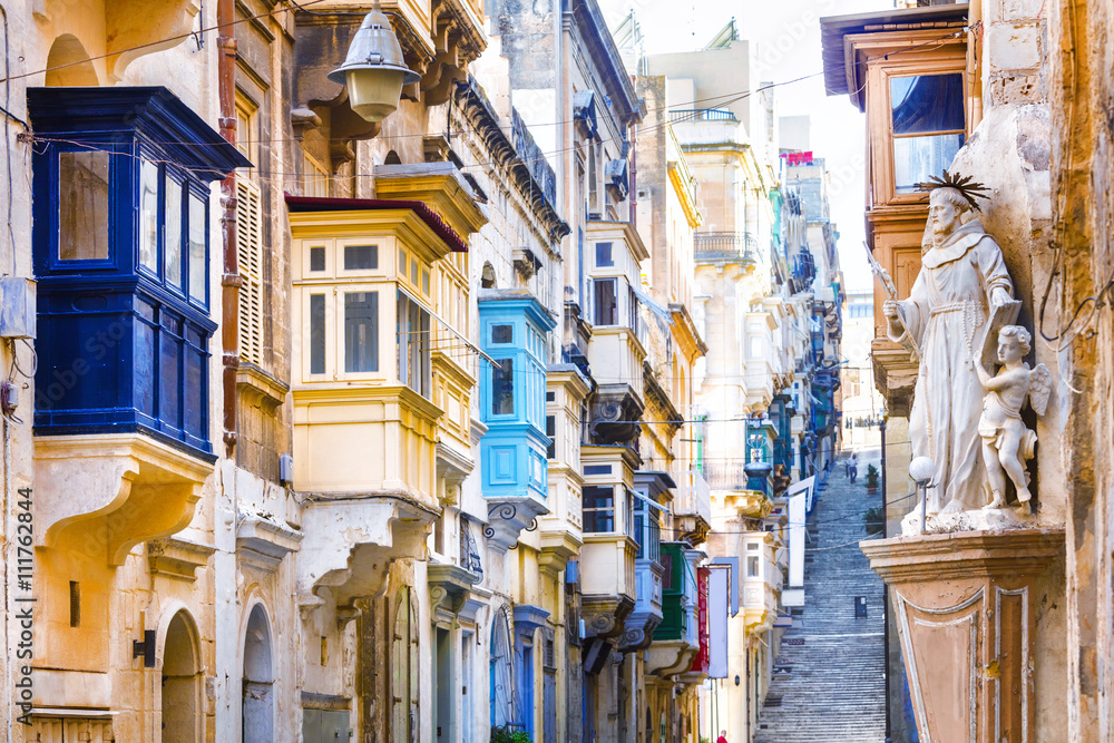 Typical narrow streets with colorful balconies in Valletta , Malta - obrazy, fototapety, plakaty 