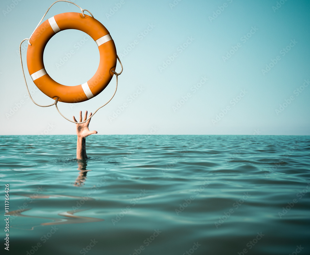 Drown man with rised hand getting lifebuoy help in sea - obrazy, fototapety, plakaty 