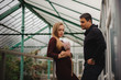 © fesenko - Happy young couple in greenhouse.