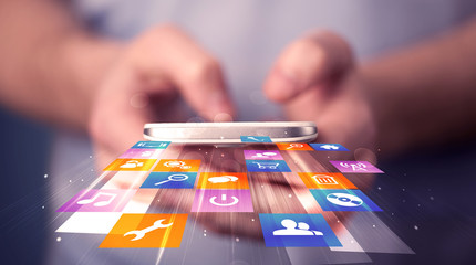 Poster - Man holding smart phone with colorful application icons