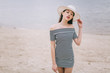 © anatoliycherkas - Beautiful stylish and fashionable girl in a hat posing on a beach.