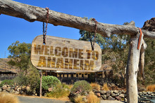 Old Wood Signboard With Text " Welcome To Anaheim" Hanging On A Branch