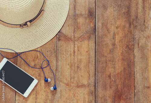 Fotografija top view of summer accessories on wooden deck