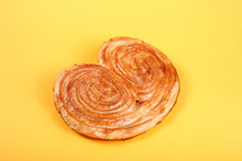 Sweet Puff Pastry On Yellow Background - Palmeras. Pastries And Bread In A Bakery
