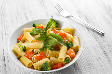 Wall Mural - Plate of pasta with salmon and broccoli on table closeup