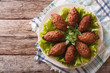 Arabic cuisine: meat appetizer kebbeh closeup on a plate. Horizontal top view
