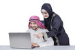 © Creativa Images - Arabic businesspeople using laptop