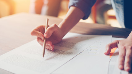 Fototapete - Woman doing paperwork. Marketing analyse. Paper and hands on the table. 