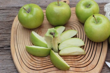 green apples is delicious on wood background.