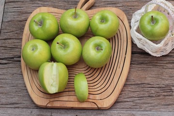 green apples is delicious on wood background.