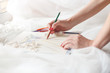© Yakobchuk Olena - Cheerful female tailor is creating bridal gown