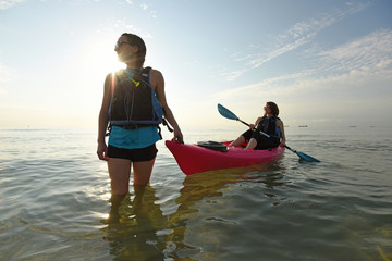 Wall Mural - Two young fit women in kayak