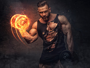 portrait of bodybuilder with burning dumbbell.