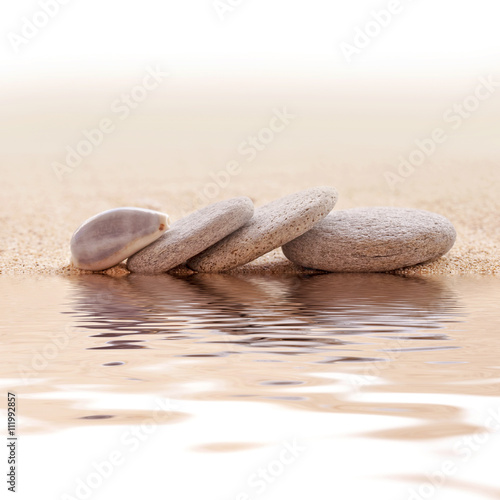 Obraz w ramie Zen stone stack and sand, water reflections