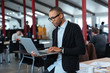 © Drobot Dean - Serious businessman is standing and using laptop