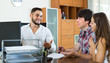 © JackF - Couple drawing up an agreement at office.