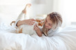 © Syda Productions - happy young woman with cat in bed at home