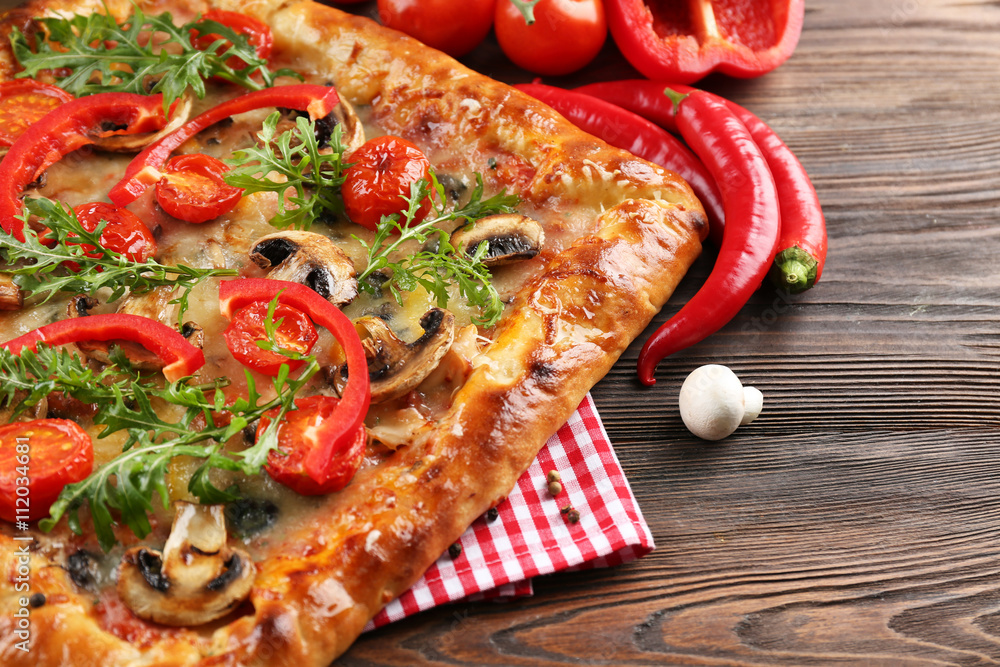 Freshly homemade pizza on wooden table closeup