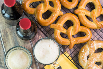 Top of view of fresh baked soft salted pretzels and bottles and