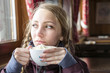© Johnér - Young woman having hot chocolate