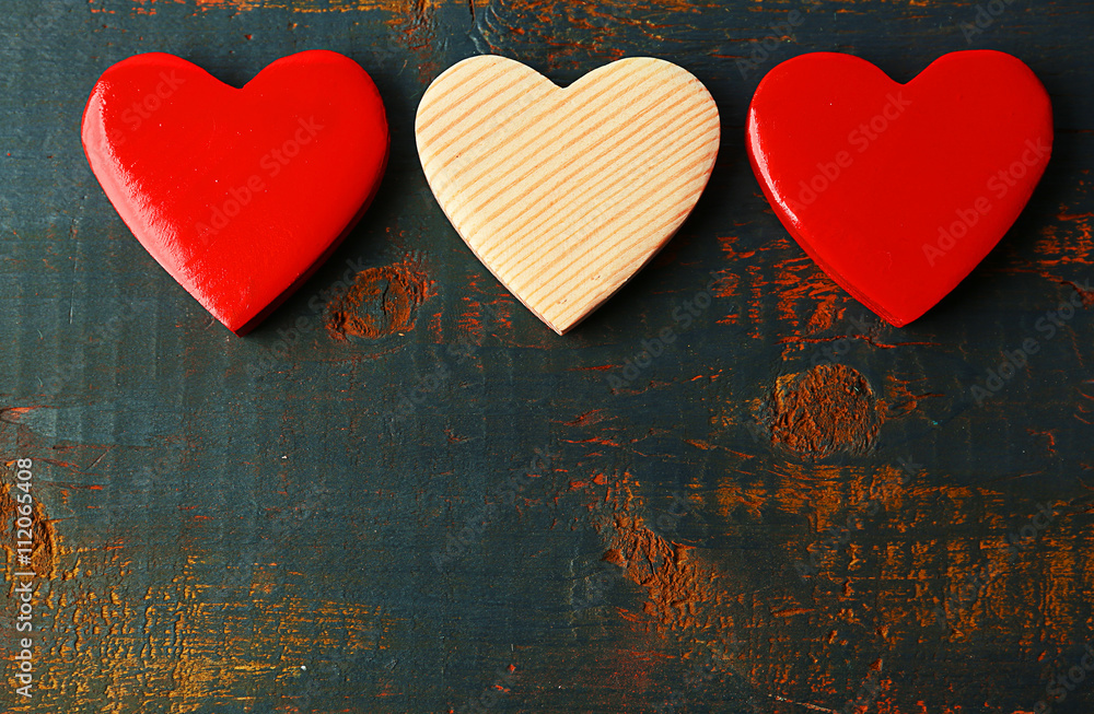 Wooden hearts on color wooden background