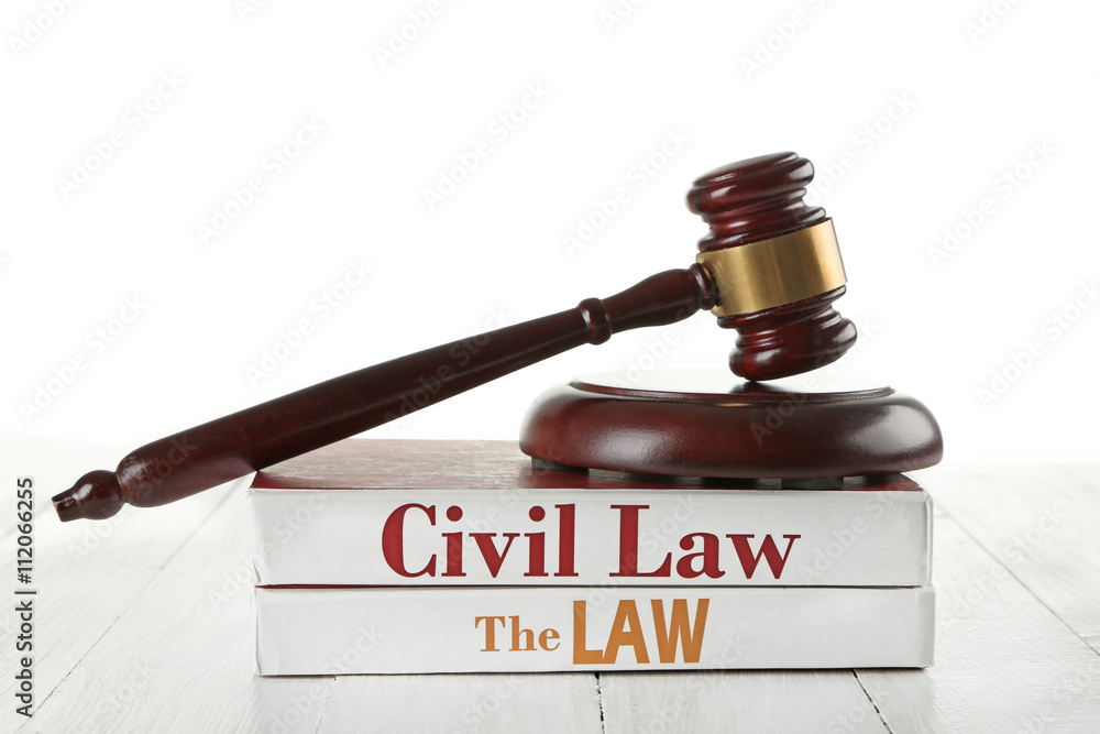 Gavel and books on wooden table on white background
