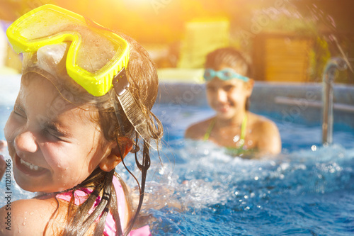 Fotografie, Obraz Children playing in pool. Two little girls having fun in the poo