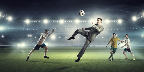 Wall Mural - Businessman and players fighting for ball