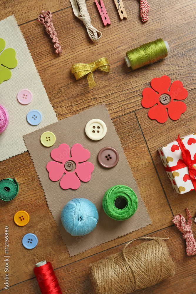 Sewing creative accessories on wooden table, top view