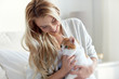 © Syda Productions - happy young woman with cat in bed at home