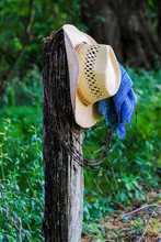 Cowboy Hat With Bandana Hanging On Fence Post