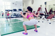 © Dusko - Beautiful and attractive young woman doing exercises at fitness gym.