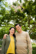 © DragonImages - Portrait of happy senior Vietnamese couple standing outdoors