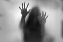 Horror Woman Behind The Matte Glass In Black And White. Blurry Hand And Body Figure Abstraction