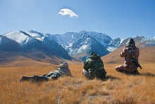 Three Hunters Looking Through Binoculars In Mountains Of Tien Sh