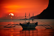 Traditional Filippino Boat At El Nido Bay In Sunset Lights. 