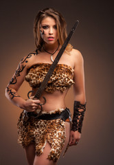 Wall Mural - Beautiful woman with sword . Fantasy and legend. Standing in fighting stance.