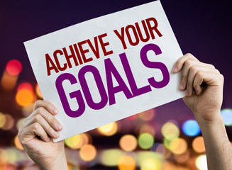 Achieve Your Goals placard with night lights on background